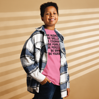 "Be Audacious Be Brilliant Be Courageous Be Fearless Be Persistent Be Brave Be Yourself!" printed on a azalea youth classic tee worn by a male also wearing a jacket