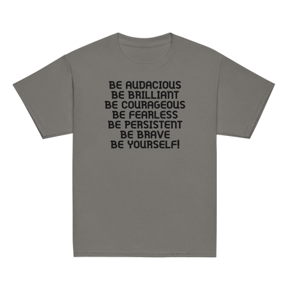 "Be Audacious Be Brilliant Be Courageous Be Fearless Be Persistent Be Brave Be Yourself!" printed on a charcoal youth classic tee laying on a flat surface