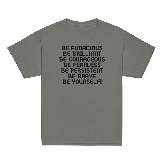 "Be Audacious Be Brilliant Be Courageous Be Fearless Be Persistent Be Brave Be Yourself!" printed on a charcoal youth classic tee laying on a flat surface