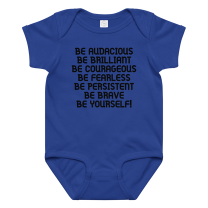 "Be Audacious Be Brilliant Be Courageous Be Fearless Be Persistent Be Brave Be Yourself!" printed on a royal baby jersey bodysuit laying on a flat surface amongst other clothes