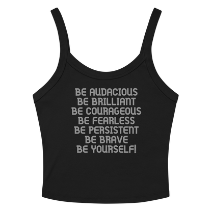 "Be Audacious Be Brilliant Be Courageous Be Fearless Be Persistent Be Brave Be Yourself!" printed on a solid black blend women's micro-rib tanktop laying on a flat surface amongst sunglasses and shorts