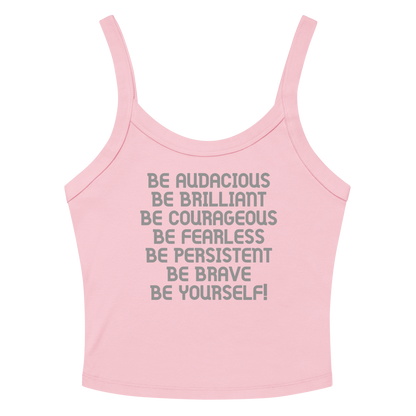 "Be Audacious Be Brilliant Be Courageous Be Fearless Be Persistent Be Brave Be Yourself!" printed on a solid pink blend women's micro-rib tanktop laying on a flat surface amongst sunglasses and shorts