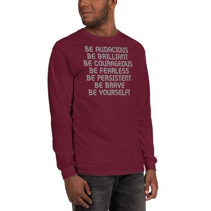 "Be Audacious Be Brilliant Be Courageous Be Fearless Be Persistent Be Brave Be Yourself!" printed on a maroon men's long sleeve shirt worn by a male