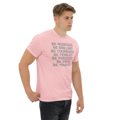 "Be Audacious Be Brilliant Be Courageous Be Fearless Be Persistent Be Brave Be Yourself!" printed on a light pink unisex classic tee worn by a male