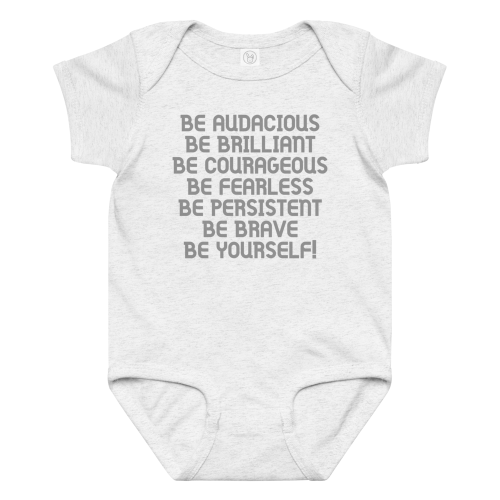 "Be Audacious Be Brilliant Be Courageous Be Fearless Be Persistent Be Brave Be Yourself!" printed on a ash baby jersey bodysuit laying on a flat surface amongst other clothes