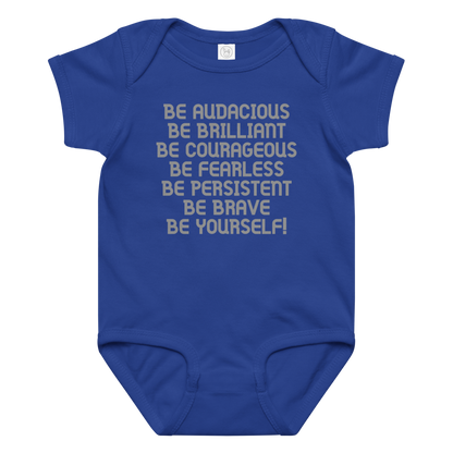 "Be Audacious Be Brilliant Be Courageous Be Fearless Be Persistent Be Brave Be Yourself!" printed on a royal baby jersey bodysuit laying on a flat surface amongst other clothes