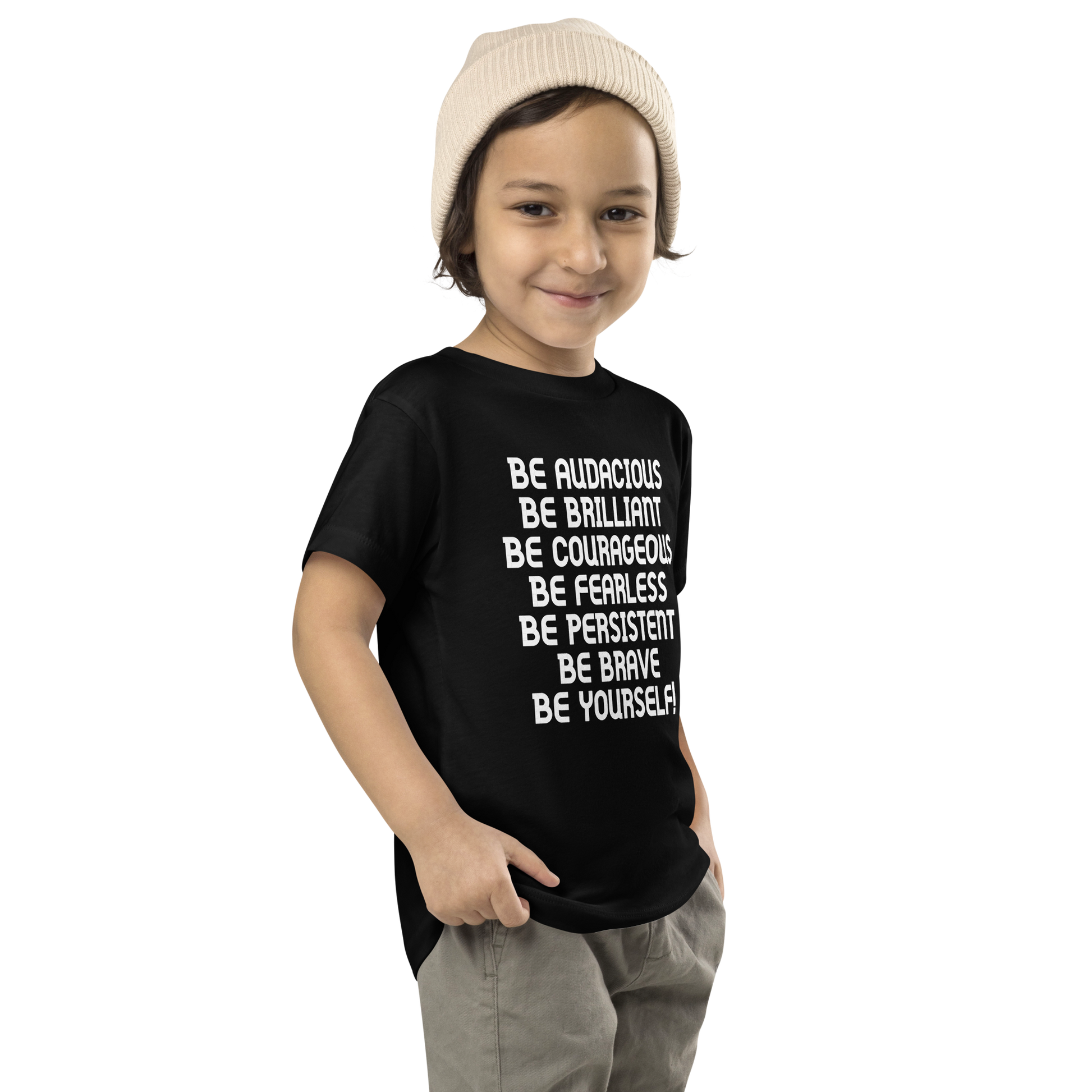 "Be Audacious Be Brilliant Be Courageous Be Fearless Be Persistent Be Brave Be Yourself!" printed on a black toddler short sleeve tee worn by a male who is also wearing a knit cap
