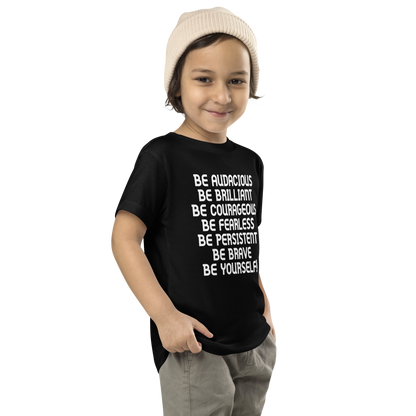 "Be Audacious Be Brilliant Be Courageous Be Fearless Be Persistent Be Brave Be Yourself!" printed on a black toddler short sleeve tee worn by a male who is also wearing a knit cap