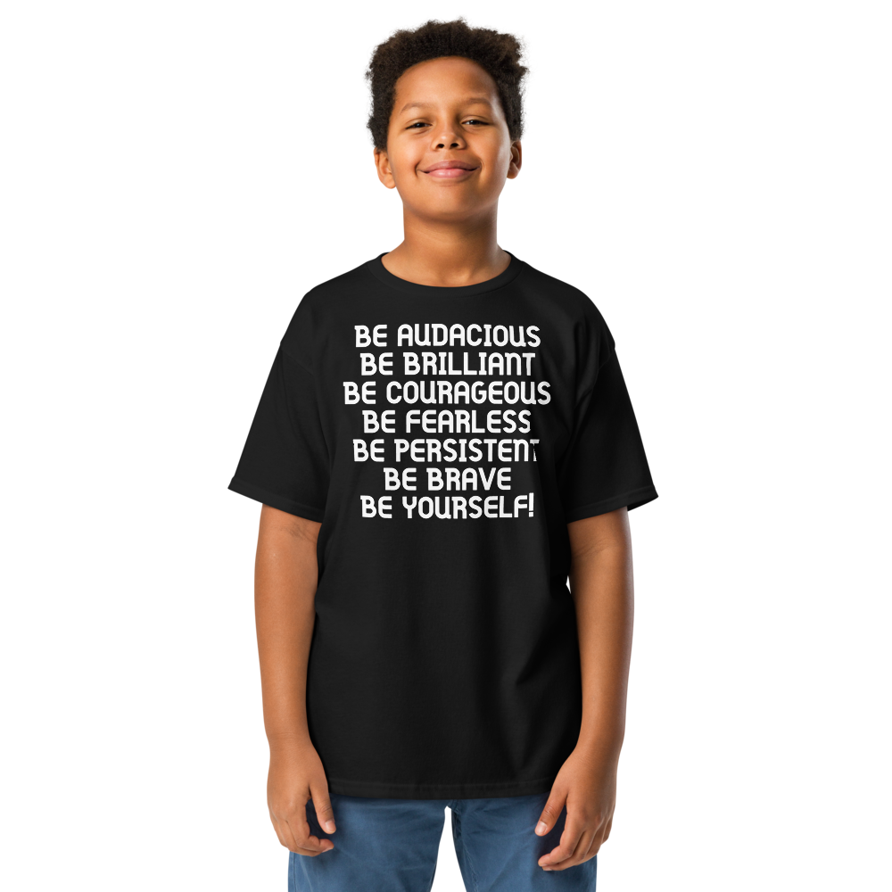 "Be Audacious Be Brilliant Be Courageous Be Fearless Be Persistent Be Brave Be Yourself!" printed on a black youth classic tee worn by a male