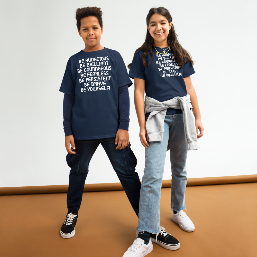 "Be Audacious Be Brilliant Be Courageous Be Fearless Be Persistent Be Brave Be Yourself!" printed on a navy youth classic tee worn by a female and male