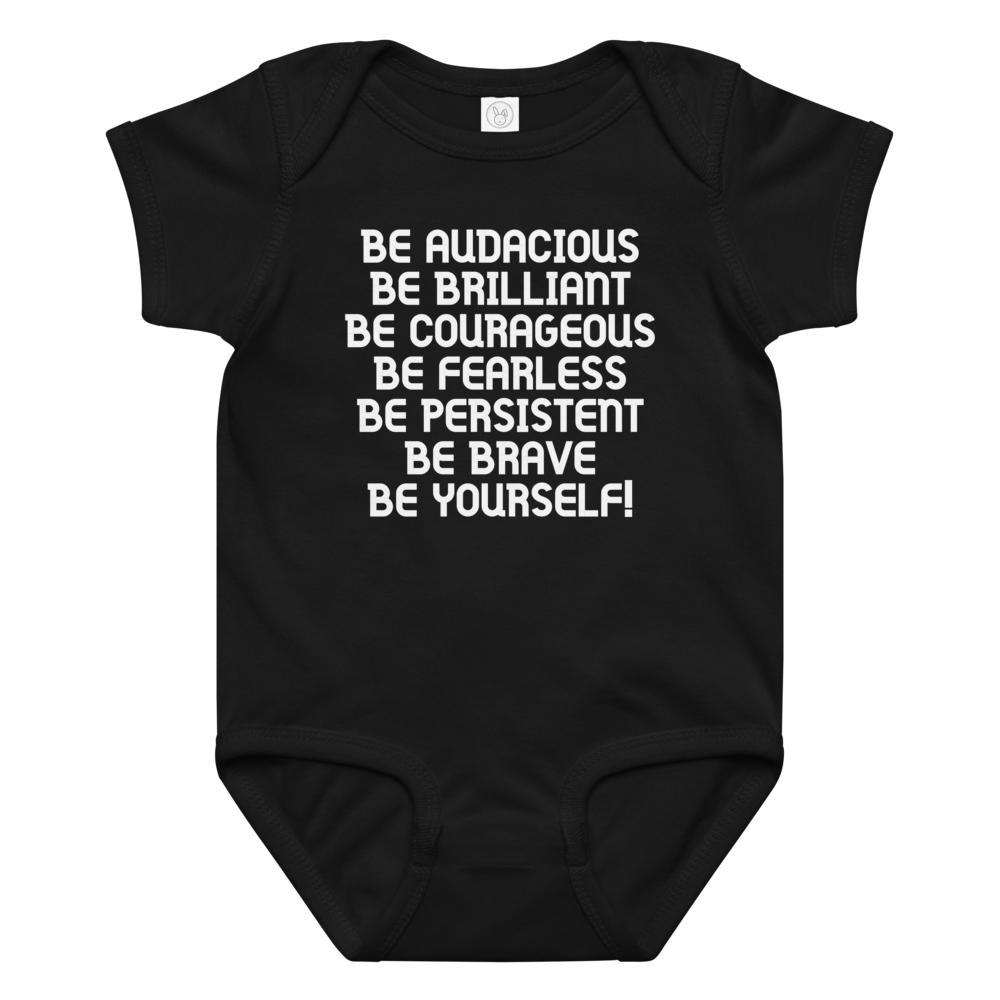 "Be Audacious Be Brilliant Be Courageous Be Fearless Be Persistent Be Brave Be Yourself!" printed on a black baby jersey bodysuit laying on a flat surface amongst other clothes