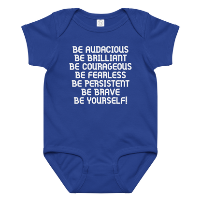 "Be Audacious Be Brilliant Be Courageous Be Fearless Be Persistent Be Brave Be Yourself!" printed on a royal baby jersey bodysuit laying on a flat surface amongst other clothes
