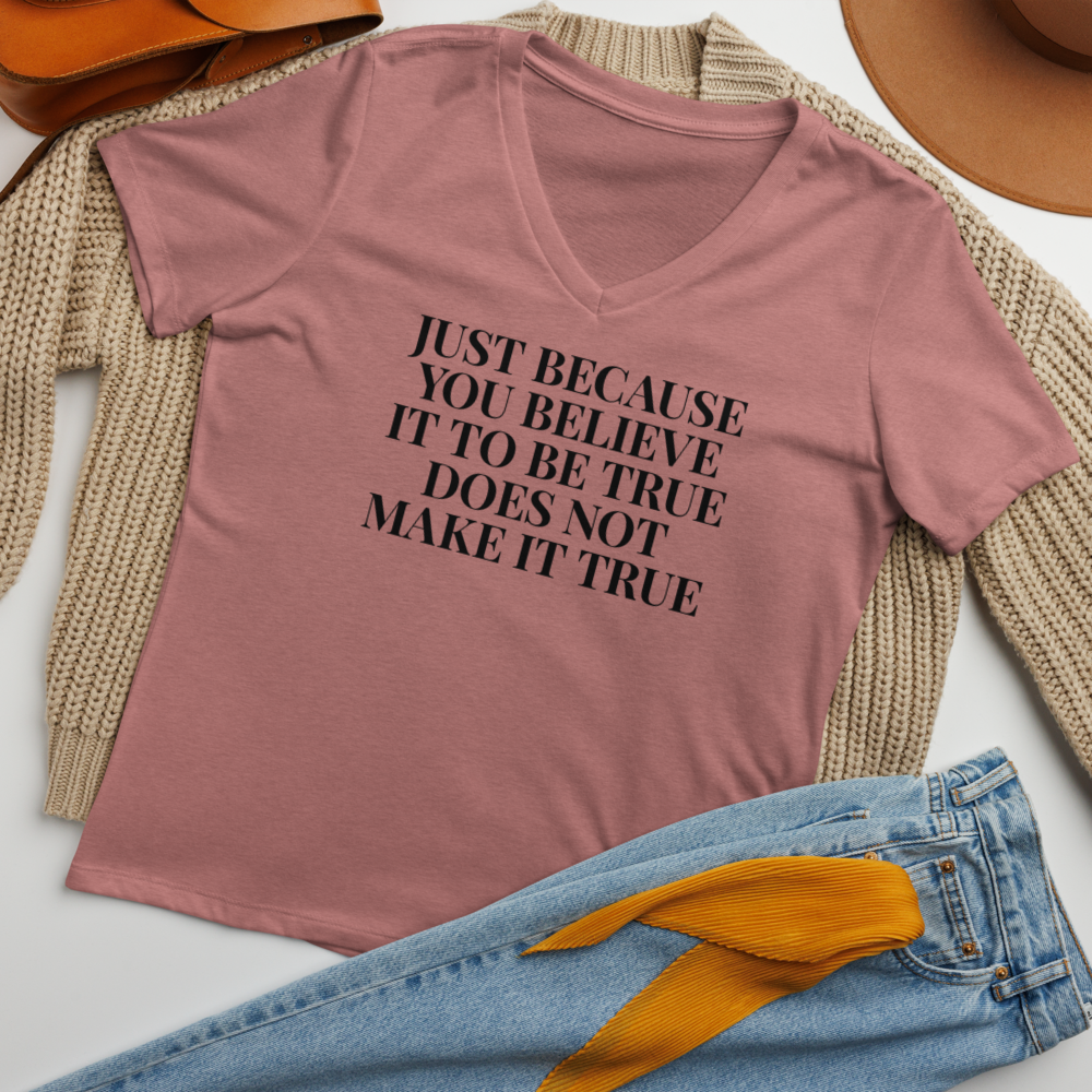 "Just because you believe it to be true does not make it true" printed on a heather mauve women's relaxed v-neck t-shirt laying on a flat surface amongst other clothes