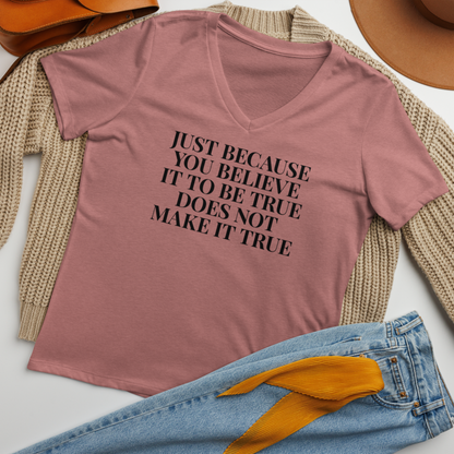 "Just because you believe it to be true does not make it true" printed on a heather mauve women's relaxed v-neck t-shirt laying on a flat surface amongst other clothes