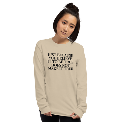 "Just because you believe it to be true does not make it true" printed on a sand men's long sleeve shirt worn by a female