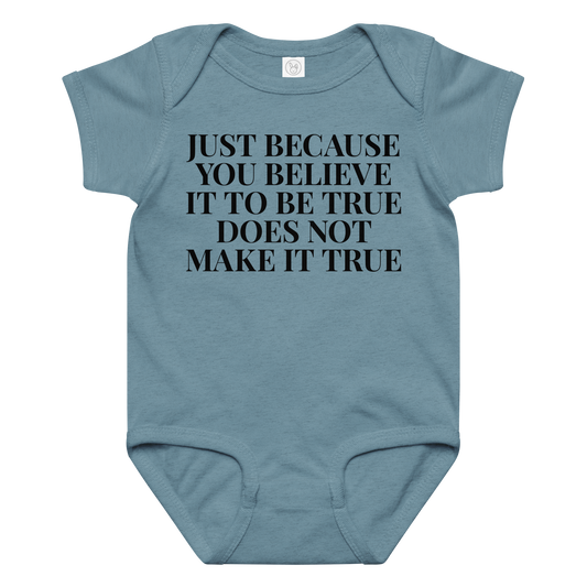 "Just because you believe it to be true does not make it true" printed on a vintage indigo baby jersey bodysuit laying on a flat surface amongst other clothes