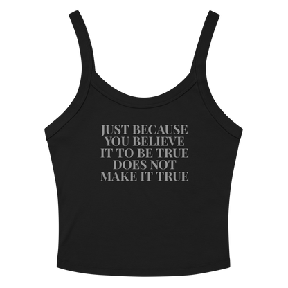 "Just because you believe it to be true does not make it true" printed on a solid black blend women's micro-rib tanktop laying on a flat surface amongst sunglasses and shorts