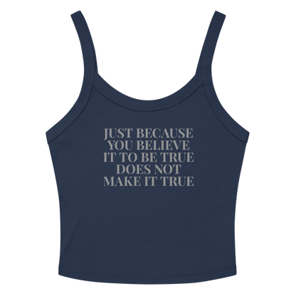 "Just because you believe it to be true does not make it true" printed on a solid navy blend women's micro-rib tanktop laying on a flat surface amongst sunglasses and shorts