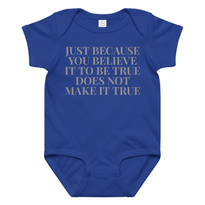 "Just because you believe it to be true does not make it true" printed on a royal baby jersey bodysuit laying on a flat surface amongst other clothes