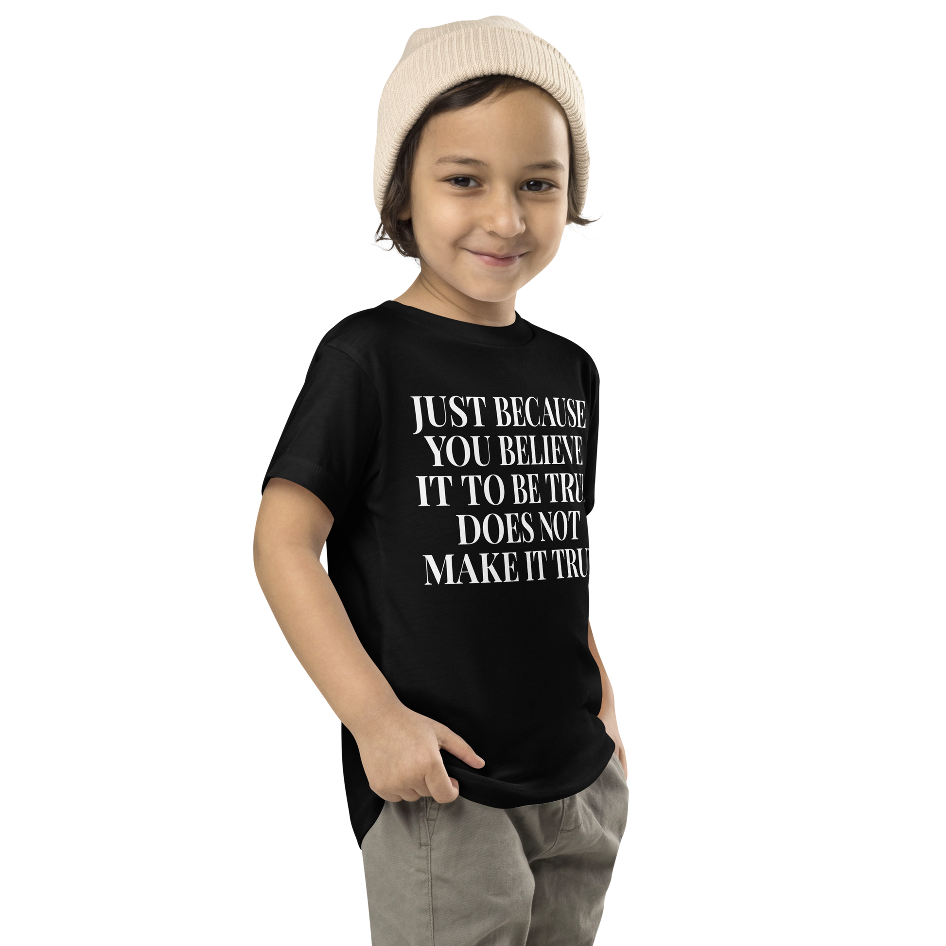"Just because you believe it to be true does not make it true" printed on a black toddler short sleeve tee worn by a male who is also wearing a knit cap
