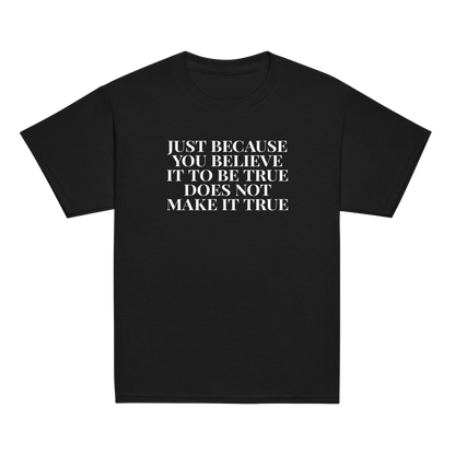 "Just because you believe it to be true does not make it true" printed on a black youth classic tee laying on a flat surface