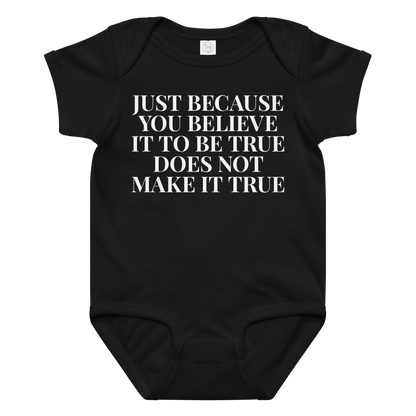 "Just because you believe it to be true does not make it true" printed on a black baby jersey bodysuit laying on a flat surface amongst other clothes