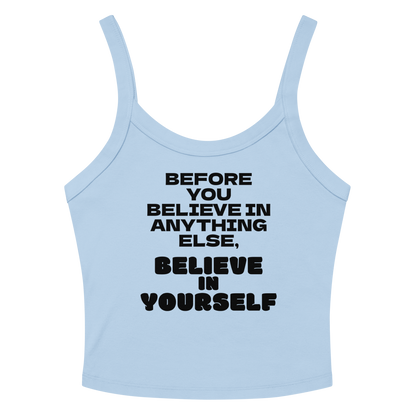 "Before you believe in anything else, believe in yourself" printed on a solid baby blue blend women's micro-rib tanktop laying on a flat surface amongst sunglasses and shorts