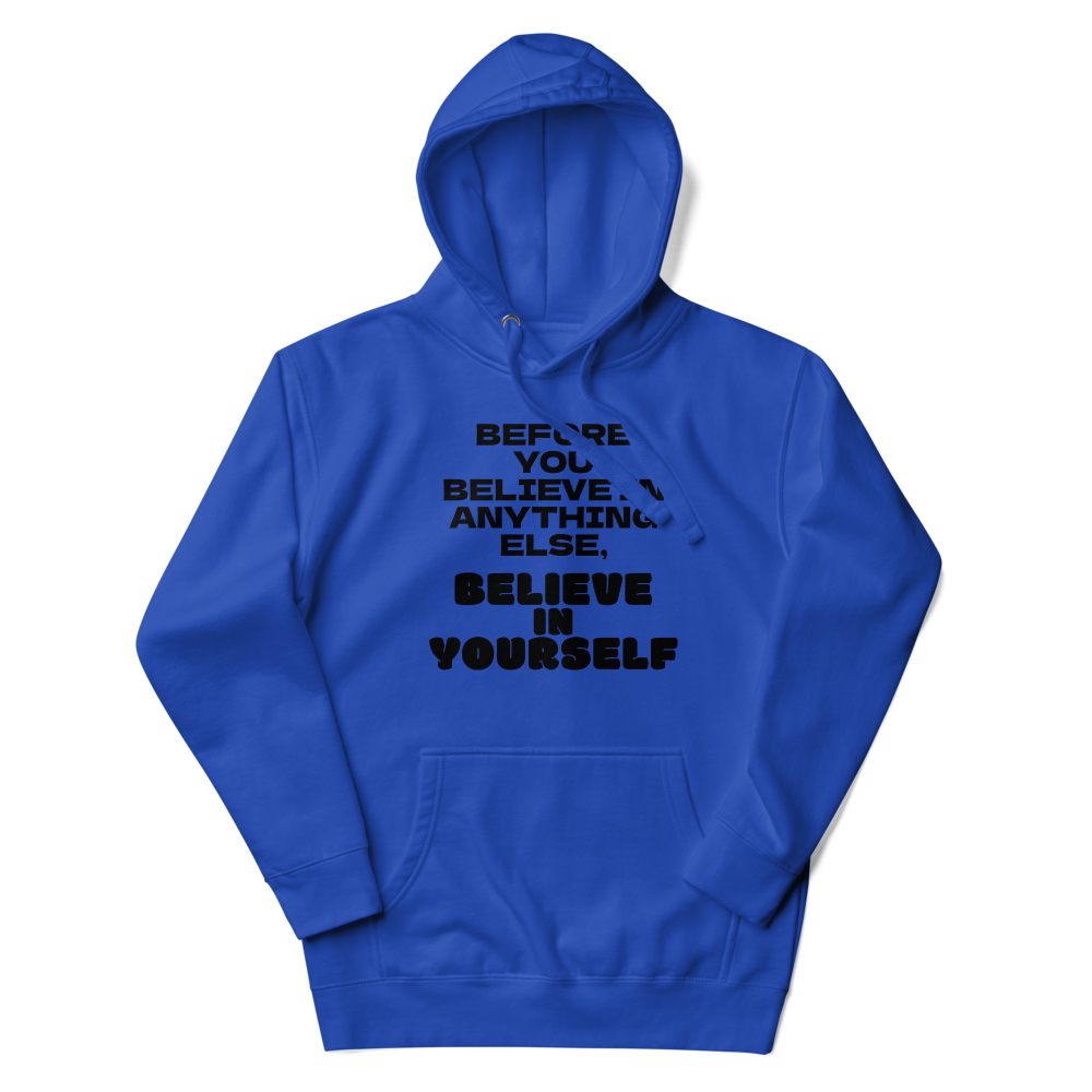 "Before you believe in anything else, believe in yourself" printed on a team royal unisex hoodie laying on a flat surface with the hood up