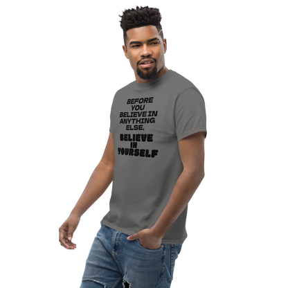 "Before you believe in anything else, believe in yourself" printed on a charcoal unisex classic tee worn by a male
