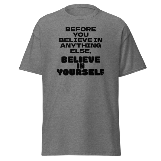 "Before you believe in anything else, believe in yourself" printed on a graphite heather unisex classic tee laying on a flat surface