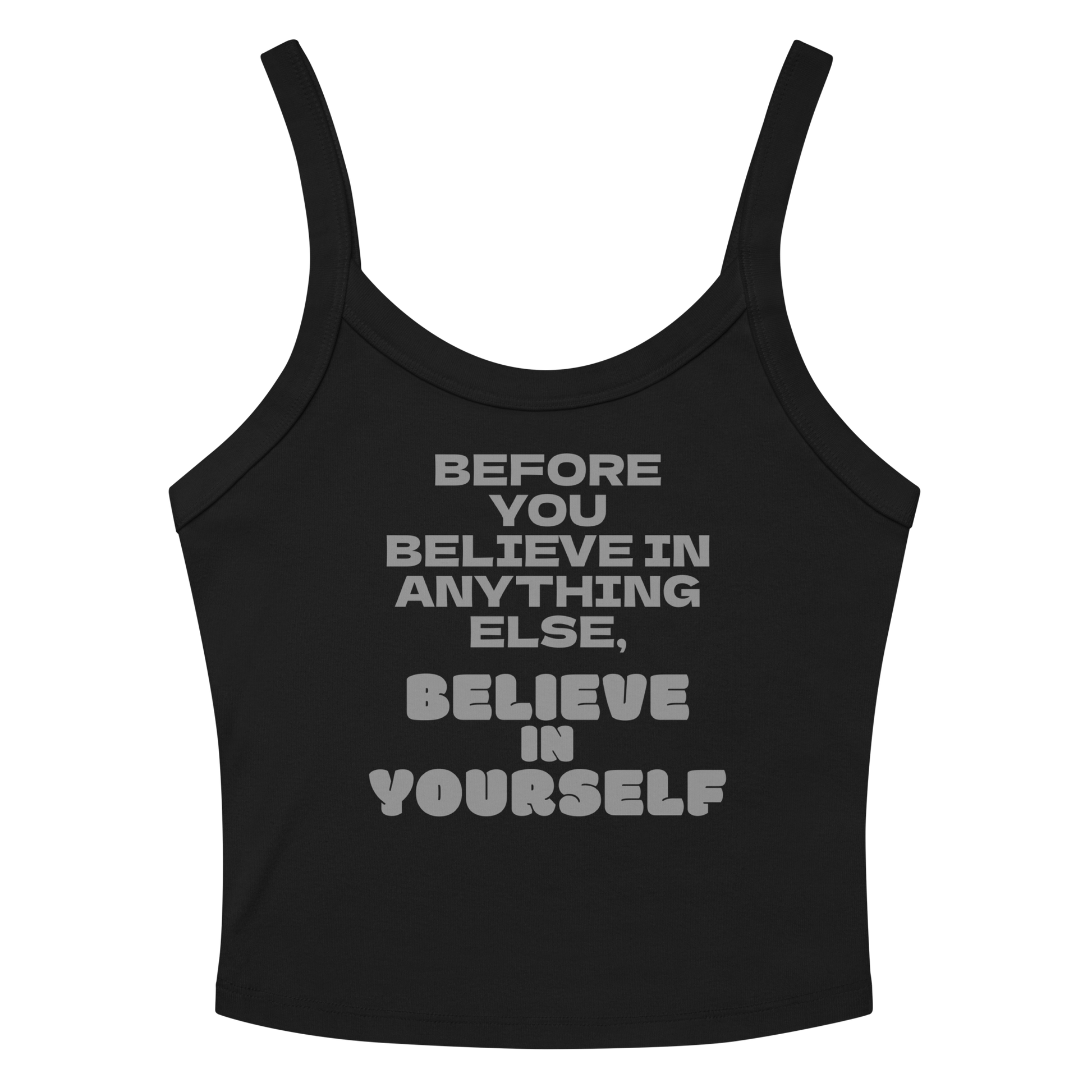 "Before you believe in anything else, believe in yourself" printed on a solid black blend women's micro-rib tanktop laying on a flat surface amongst sunglasses and shorts
