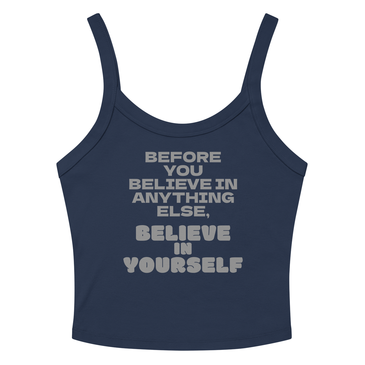 "Before you believe in anything else, believe in yourself" printed on a solid navy blend women's micro-rib tanktop laying on a flat surface amongst sunglasses and shorts