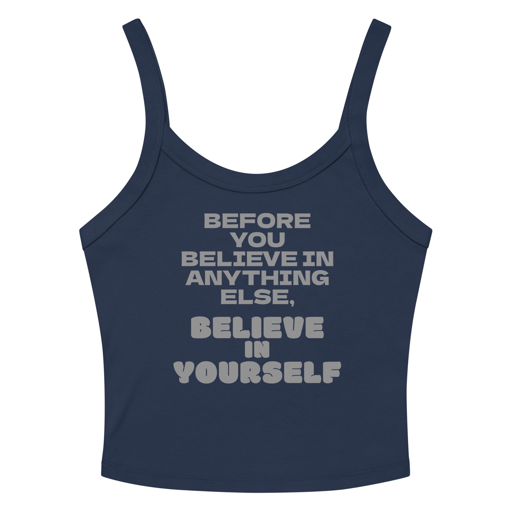 "Before you believe in anything else, believe in yourself" printed on a solid navy blend women's micro-rib tanktop laying on a flat surface amongst sunglasses and shorts