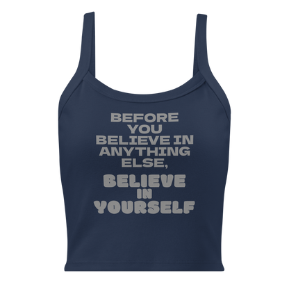 "Before you believe in anything else, believe in yourself" printed on a solid navy blend women's micro-rib tanktop laying on a flat surface