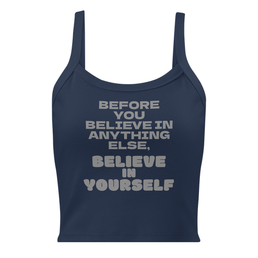 "Before you believe in anything else, believe in yourself" printed on a solid navy blend women's micro-rib tanktop laying on a flat surface