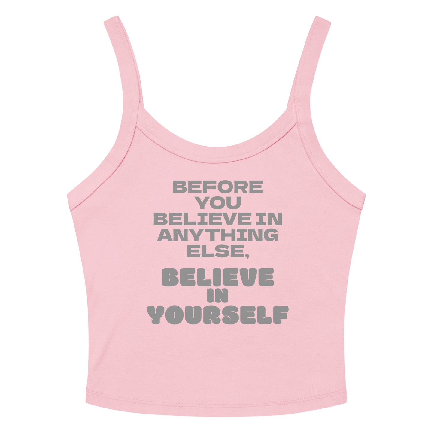 "Before you believe in anything else, believe in yourself" printed on a solid pink blend women's micro-rib tanktop laying on a flat surface amongst sunglasses and shorts