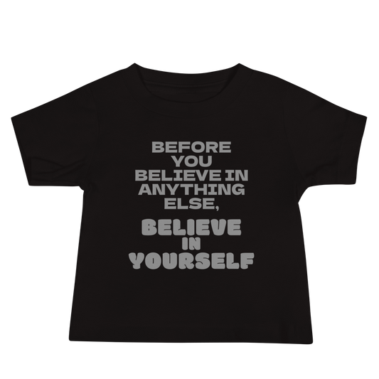 "Before you believe in anything else, believe in yourself" printed on a black baby jersey short sleeve tee laying on a flat surface