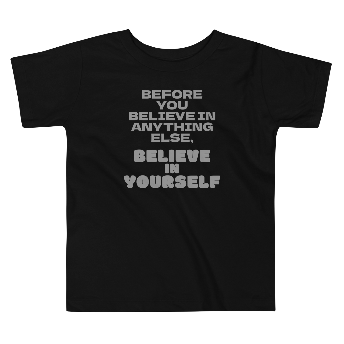 "Before you believe in anything else, believe in yourself" printed on a black toddler short sleeve tee laying on a flat surface