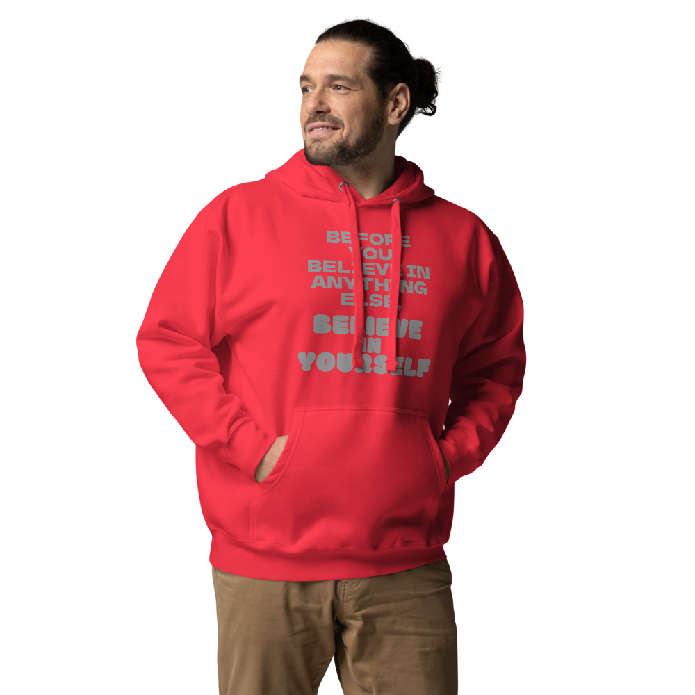"Before you believe in anything else, believe in yourself" printed on a team red unisex hoodie worn by a male