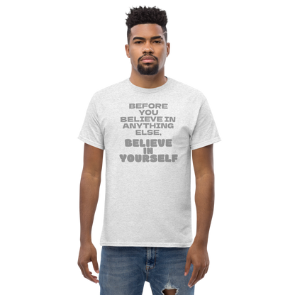 "Before you believe in anything else, believe in yourself" printed on a ash unisex classic tee worn by a male