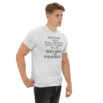 "Before you believe in anything else, believe in yourself" printed on a ash unisex classic tee worn by a male