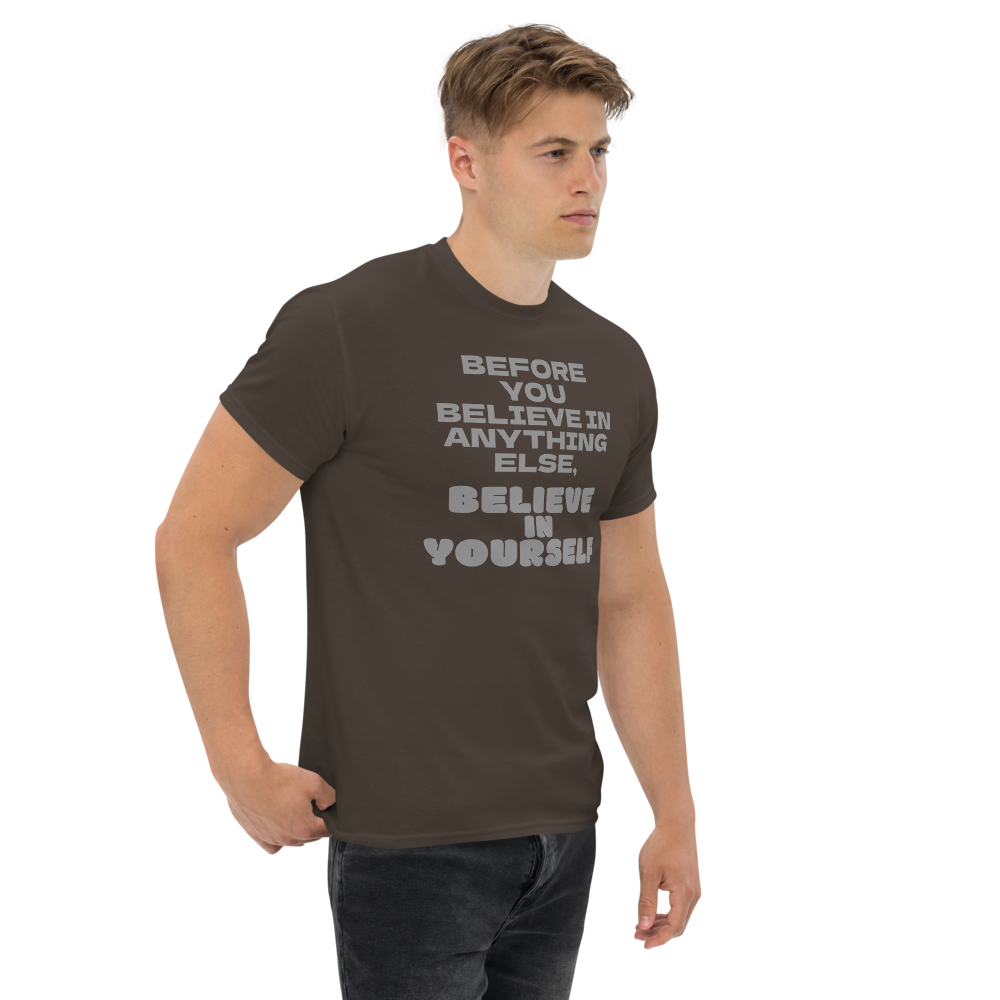 "Before you believe in anything else, believe in yourself" printed on a dark chocolate unisex classic tee worn by a male