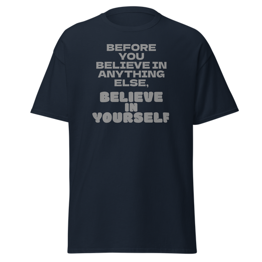 "Before you believe in anything else, believe in yourself" printed on a navy unisex classic tee laying on a flat surface