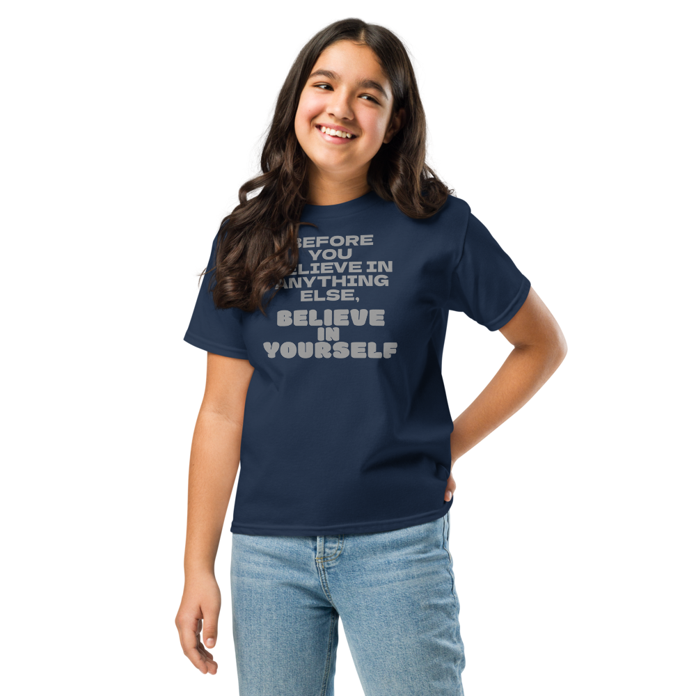 "Before you believe in anything else, believe in yourself" printed on a navy youth classic tee worn by a female
