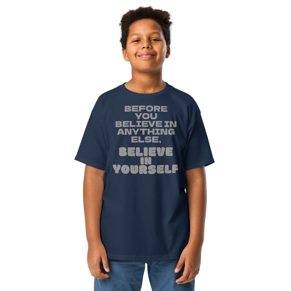 "Before you believe in anything else, believe in yourself" printed on a navy youth classic tee worn by a male