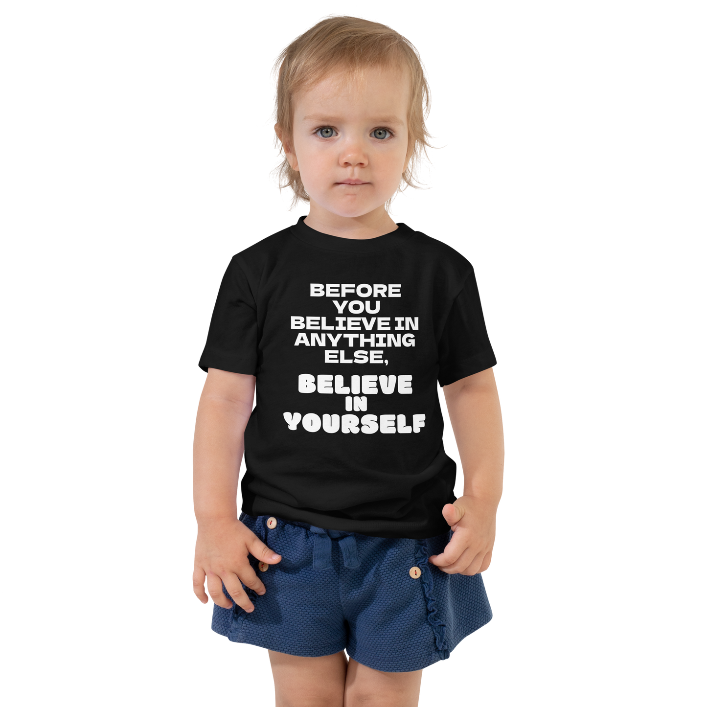 "Before you believe in anything else, believe in yourself" printed on a black toddler short sleeve tee worn by a female
