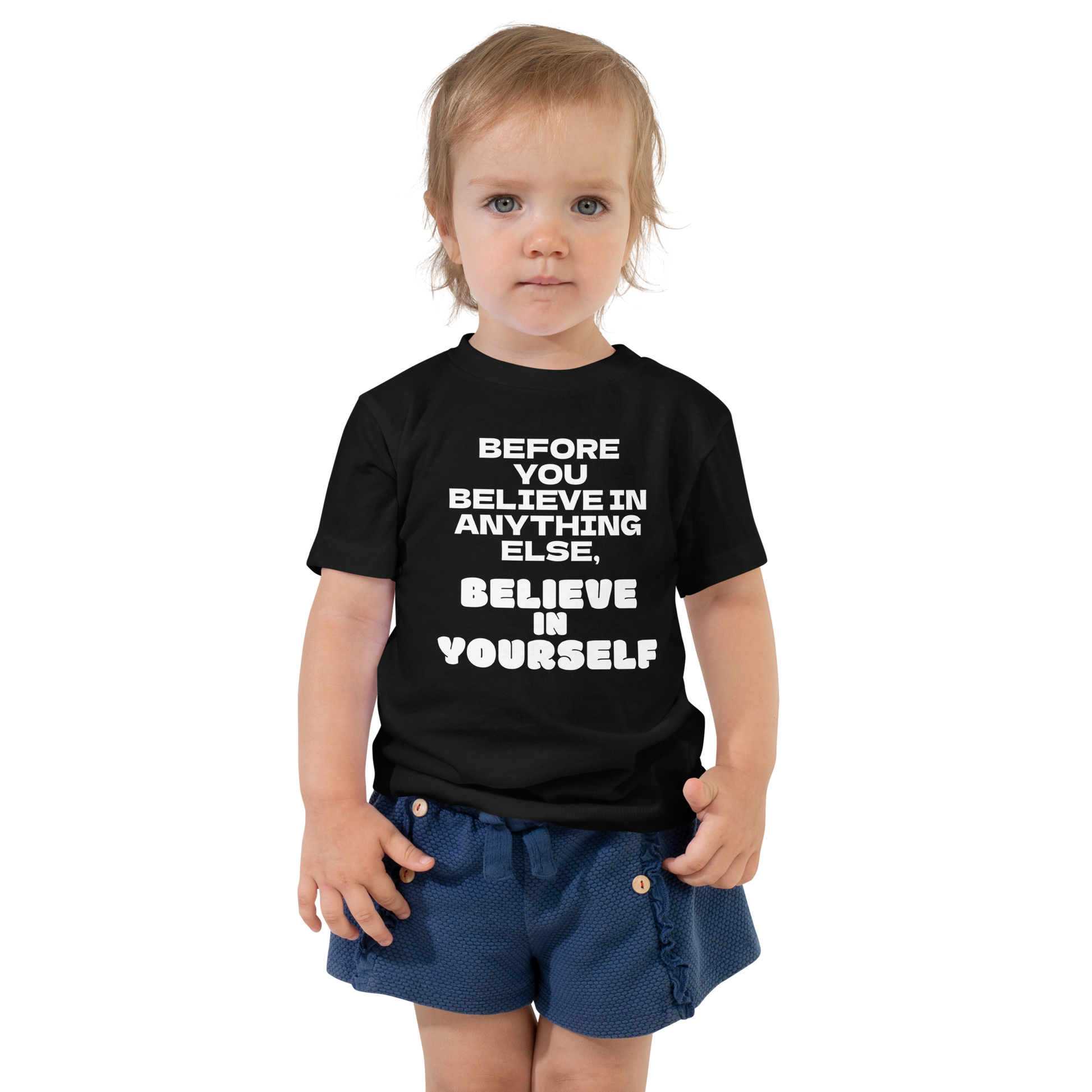 "Before you believe in anything else, believe in yourself" printed on a black toddler short sleeve tee worn by a female