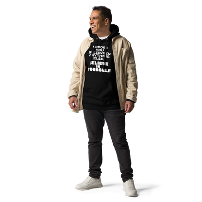 "Before you believe in anything else, believe in yourself" printed on a black unisex hoodie worn by a male with a jacket on top