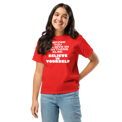 "Before you believe in anything else, believe in yourself" printed on a red youth classic tee worn by a female