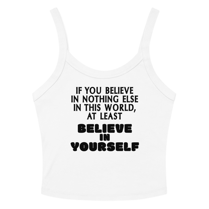 "If you believe in nothing else in this world, at least believe in yourself" printed on a solid white blend women's micro-rib tanktop laying on a flat surface amongst sunglasses and shorts